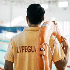 Lifeguard, back and person with swimming, pool or safety lifebuoy for rescue support, help or life